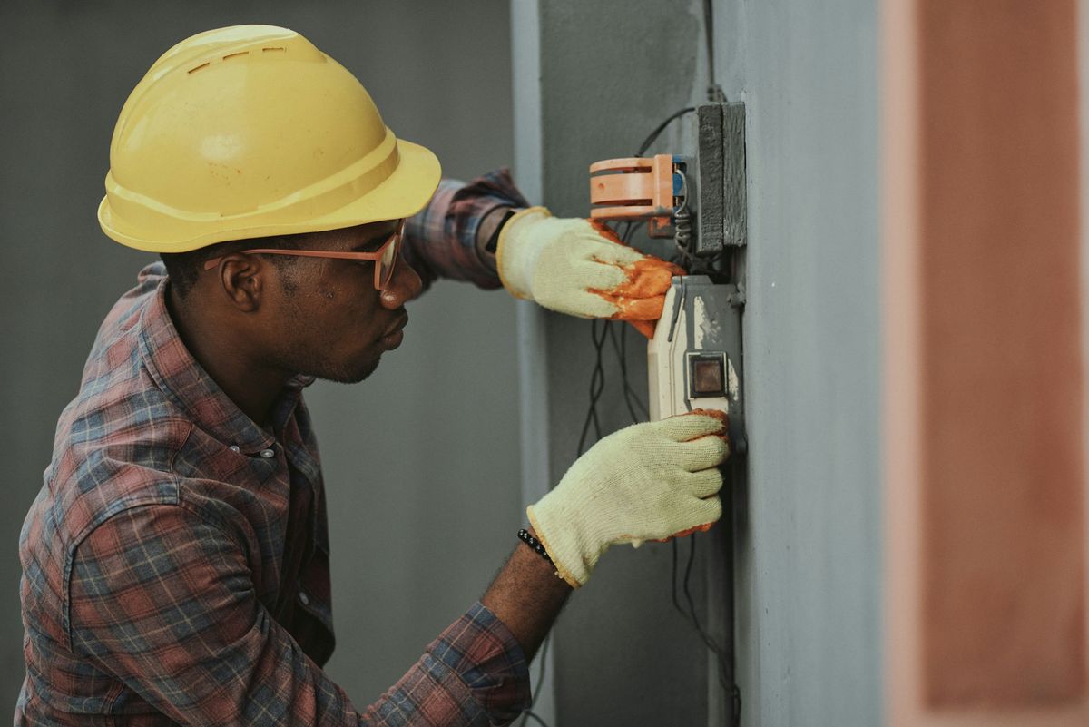 Professional electrician working with electrical wiring