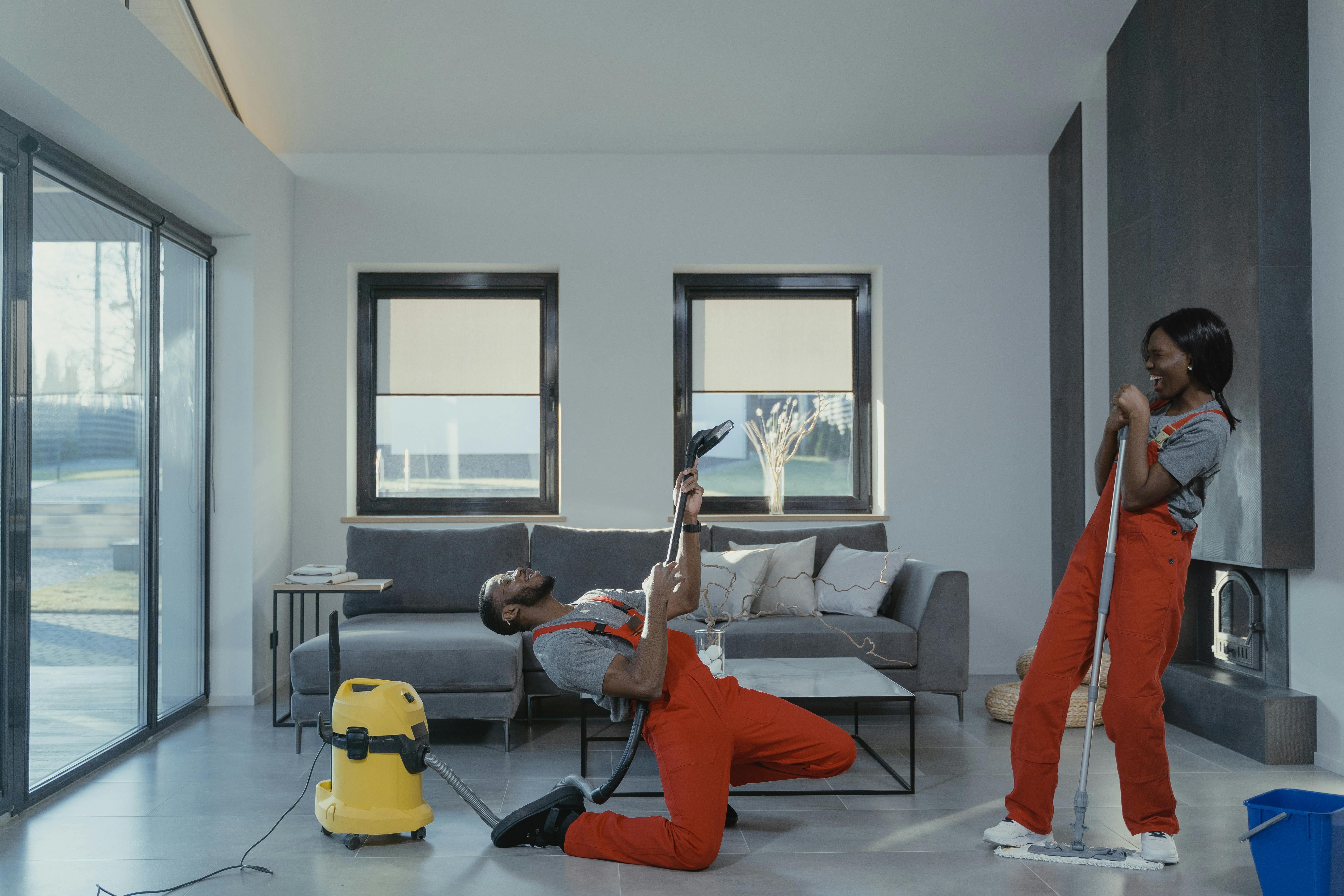 Two cleaning professionals working in a modern home.