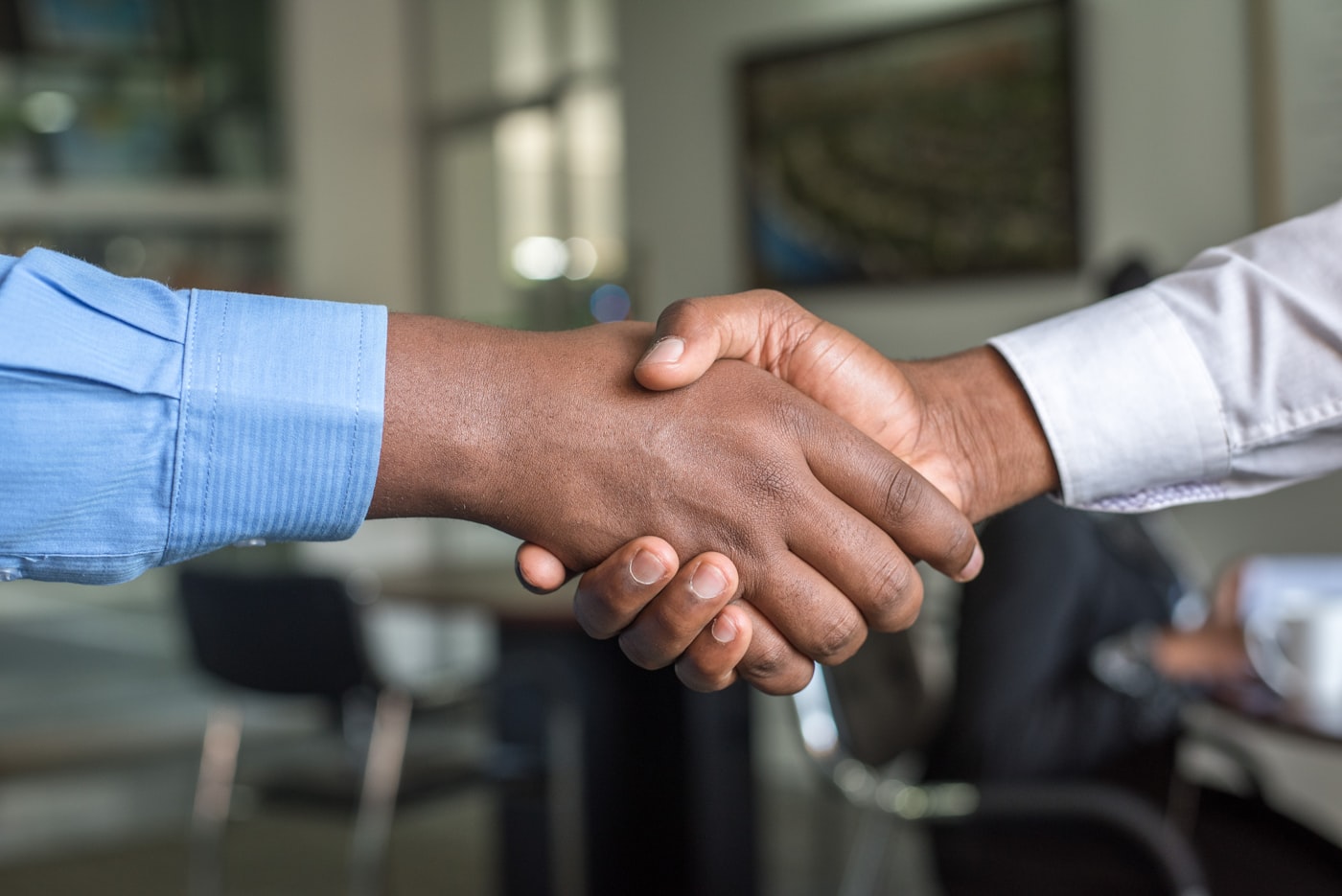 Two professionals sealing a service agreement with a handshake.